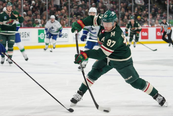 Feb 19, 2024; Saint Paul, Minnesota, USA; Minnesota Wild left wing Kirill Kaprizov (97) shoots against the Vancouver Canucks in the second period at Xcel Energy Center.